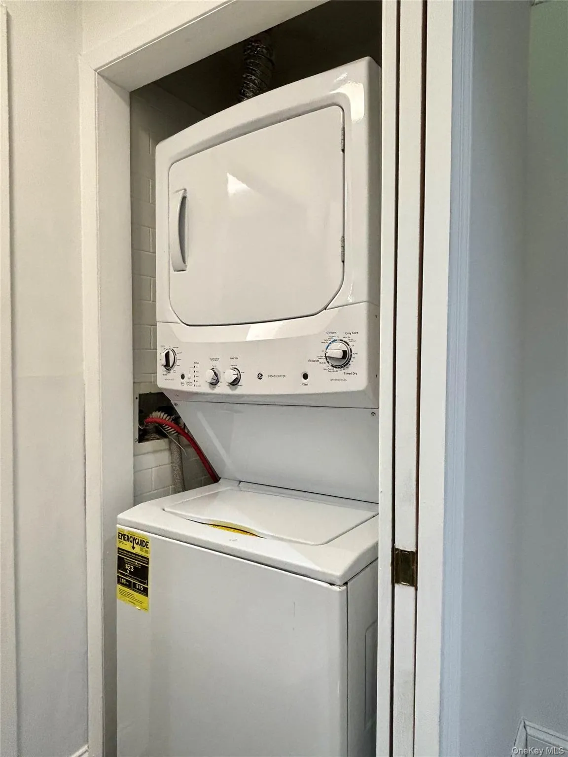 Laundry area featuring stacked washer/dryer Laundry area featuring stacked washer/dryer