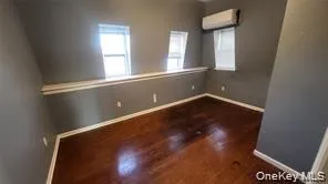 Unfurnished room featuring dark wood-type flooring and baseboards Unfurnished room featuring dark wood-type flooring and baseboards