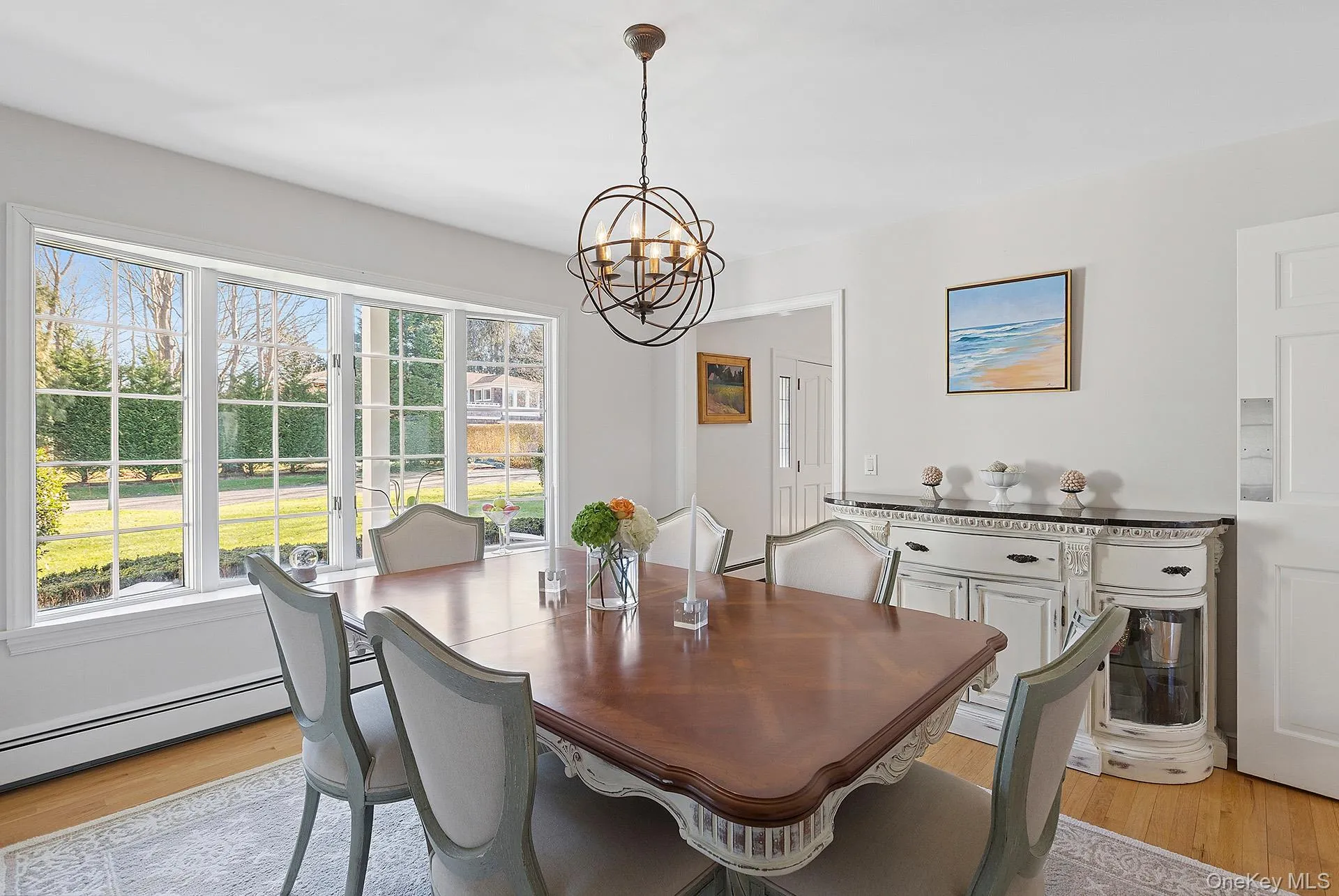 Dining room featuring light wood-style flooring and a chandelier Dining room featuring light wood-style flooring and a chandelier