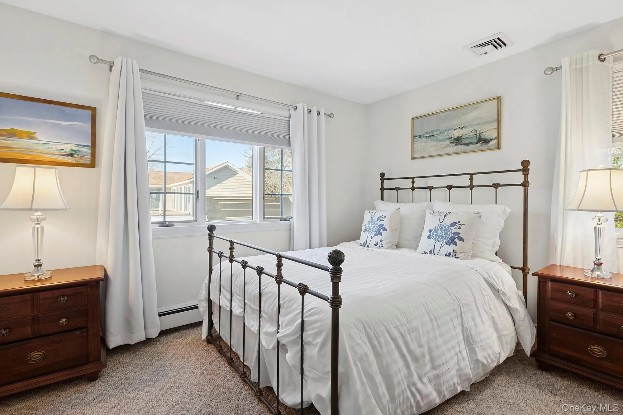 Bedroom featuring carpet floors and a baseboard heating unit Bedroom featuring carpet floors and a baseboard heating unit
