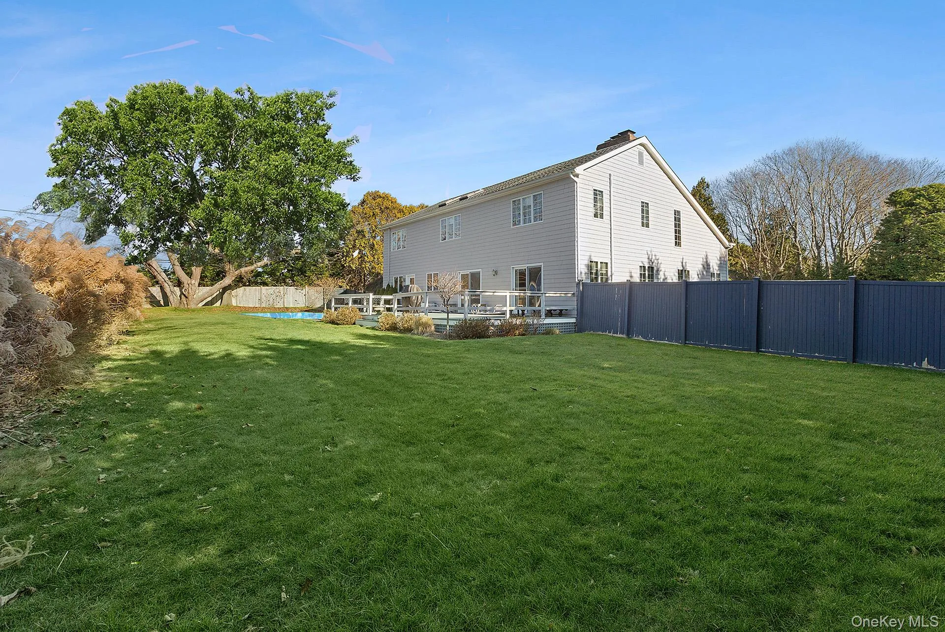 Fenced backyard featuring a pool and a deck Fenced backyard featuring a pool and a deck