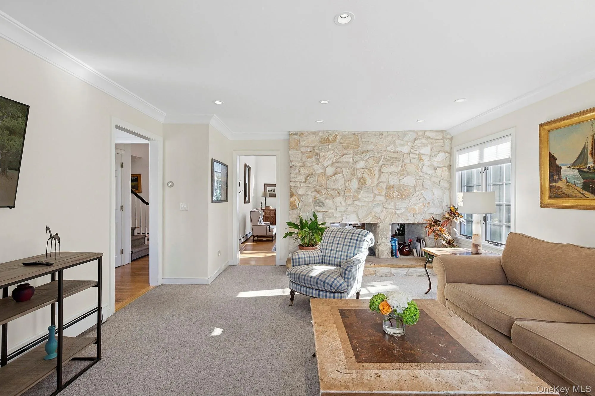 Living area featuring ornamental molding, a fireplace, carpet floors, and recessed lighting Living area featuring ornamental molding, a fireplace, carpet floors, and recessed lighting