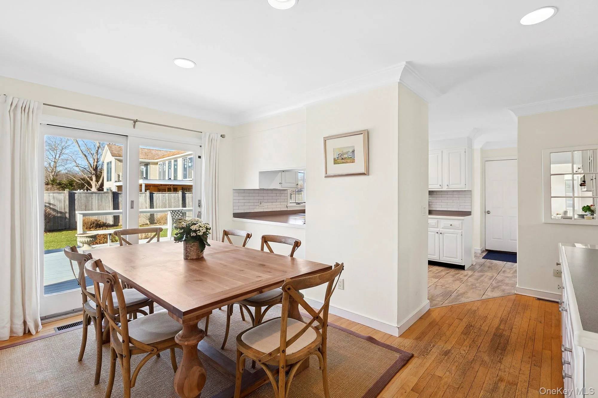 Dining area featuring light wood-style floors, ornamental molding, and recessed lighting Dining area featuring light wood-style floors, ornamental molding, and recessed lighting