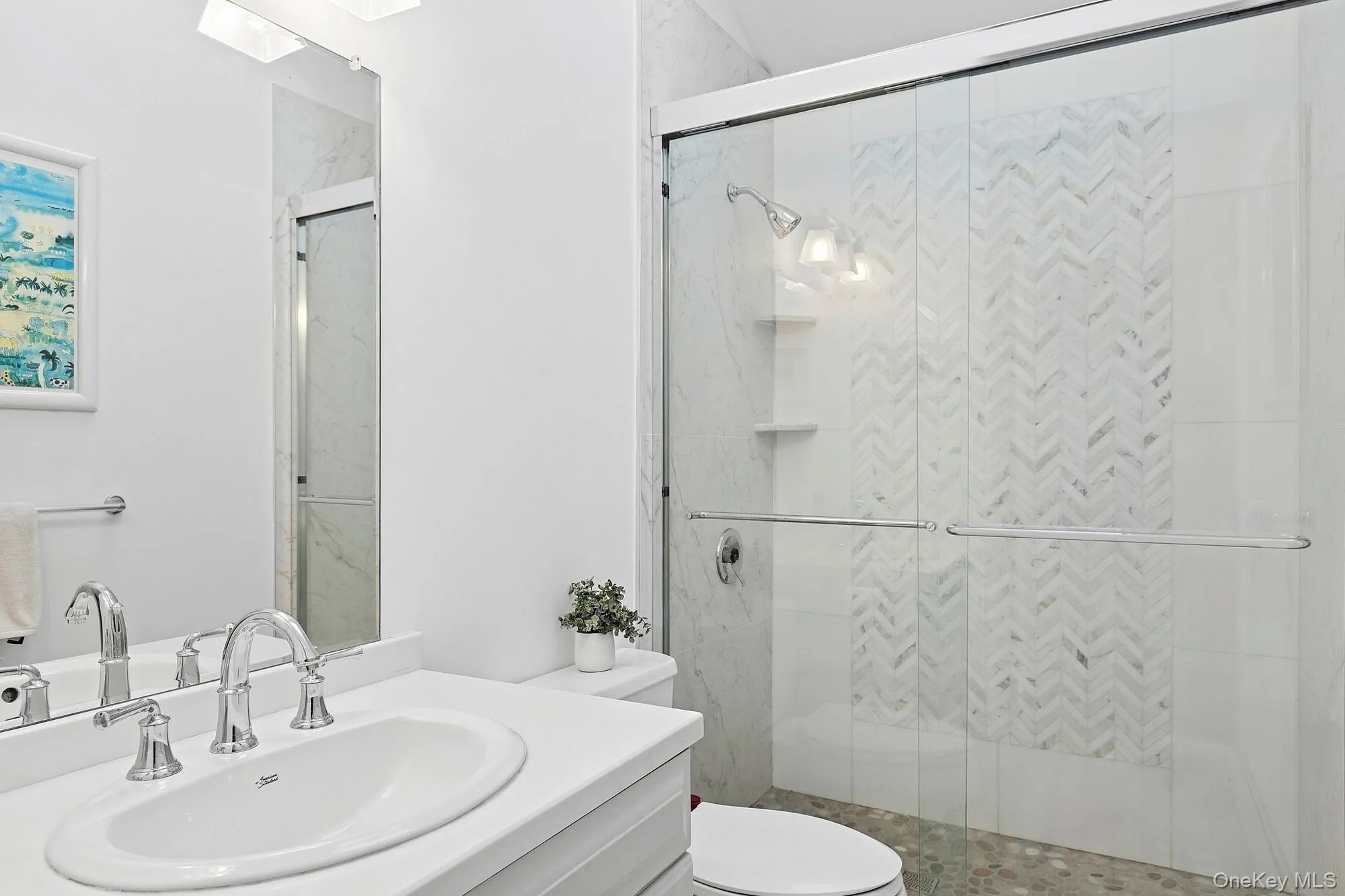 Full bathroom with vanity, a marble finish shower, and a skylight Full bathroom with vanity, a marble finish shower, and a skylight