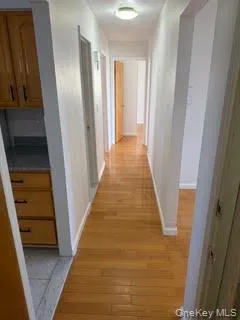 Corridor with light wood-type flooring and baseboards Corridor with light wood-type flooring and baseboards