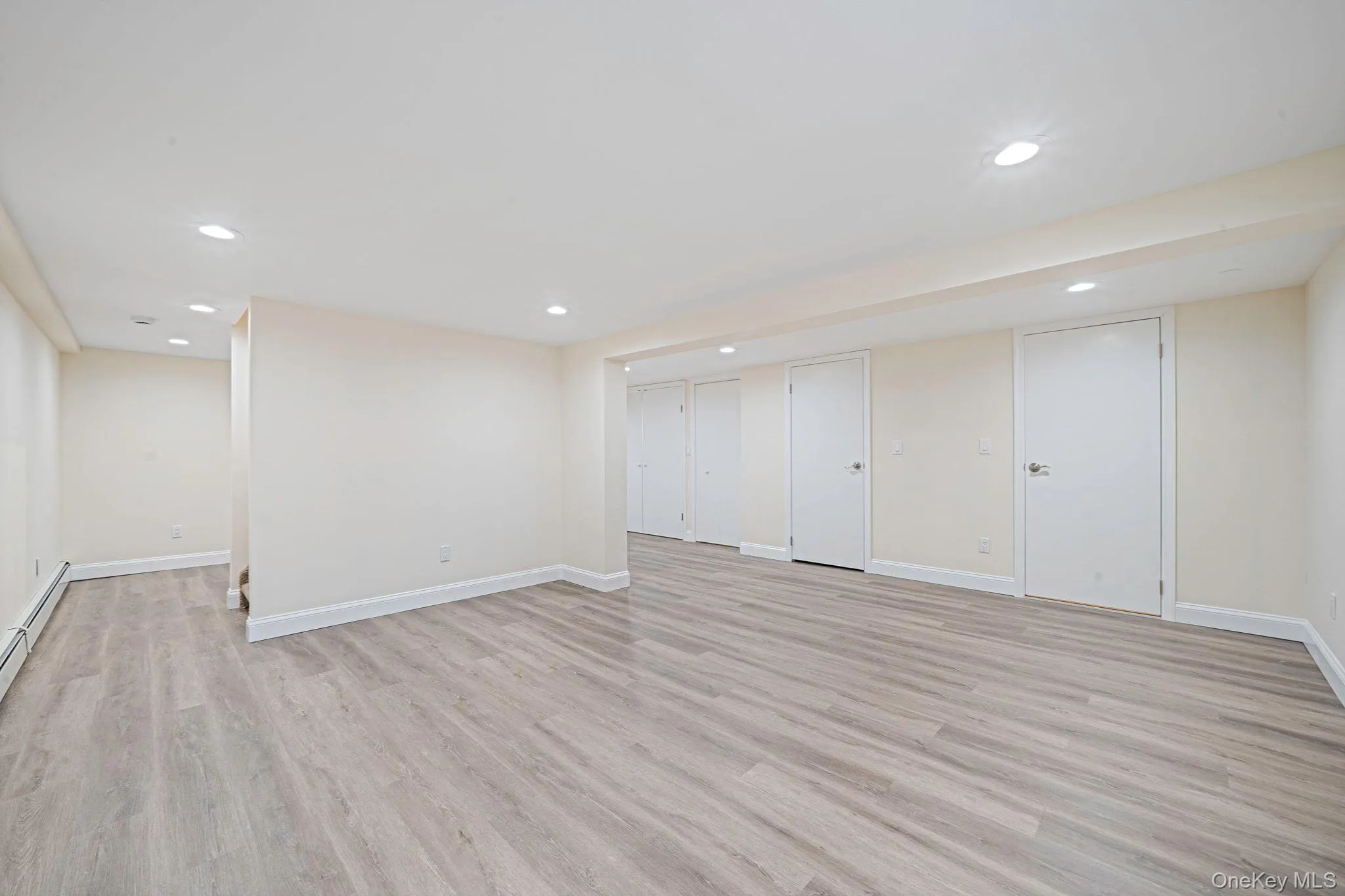 Finished basement featuring light wood finished floors and recessed lighting. Finished basement featuring light wood finished floors and recessed lighting.