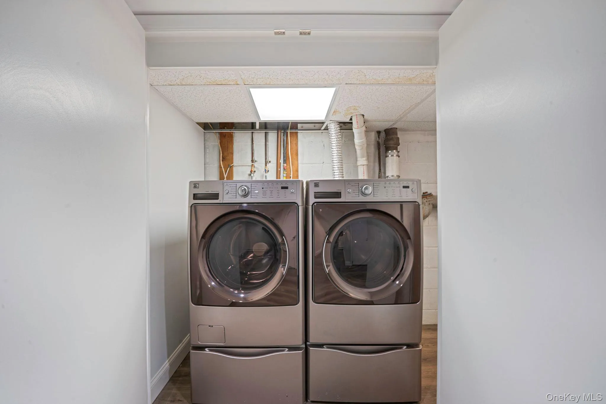 Laundry area in basement featuring washer and dryer. Laundry area in basement featuring washer and dryer.