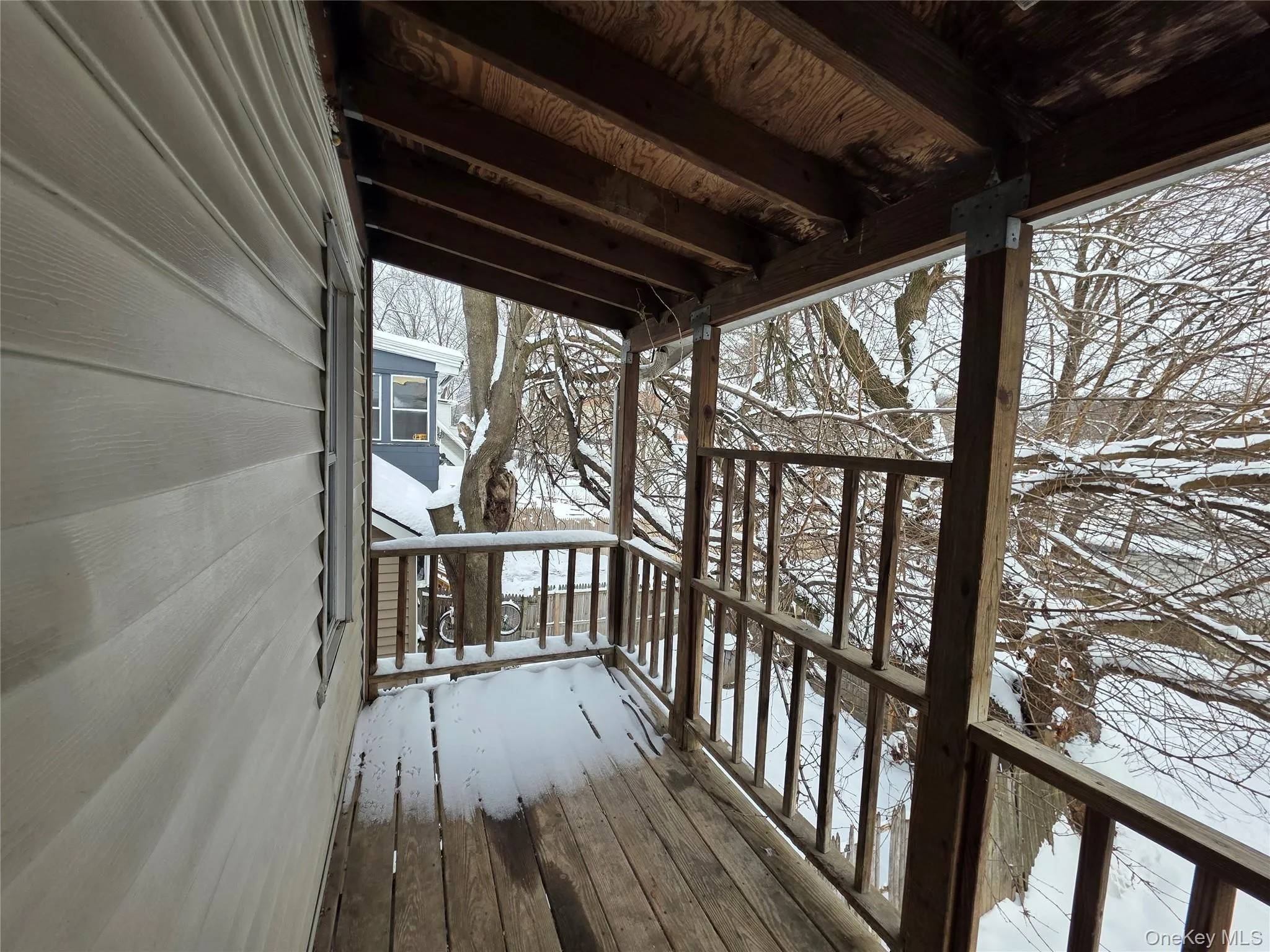 Snow covered deck featuring a porch Snow covered deck featuring a porch