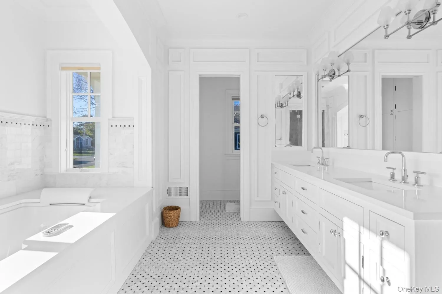Full bathroom with double vanity, a bath, and ornamental molding Full bathroom with double vanity, a bath, and ornamental molding