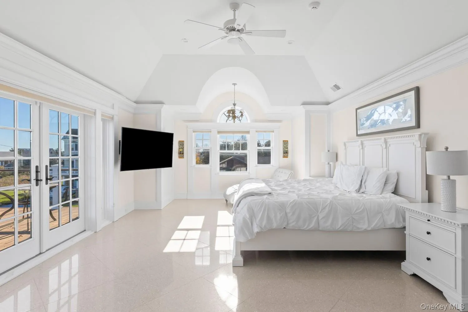 Bedroom featuring access to exterior, a ceiling fan, french doors, and vaulted ceiling Bedroom featuring access to exterior, a ceiling fan, french doors, and vaulted ceiling
