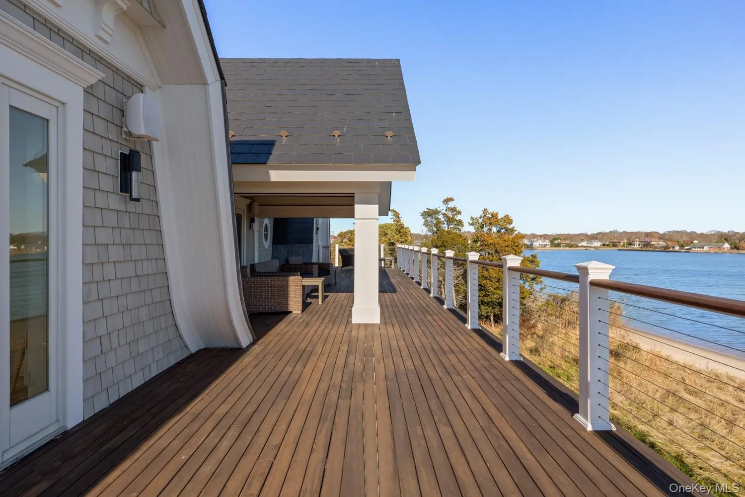 Wooden deck featuring a water view and outdoor lounge area Wooden deck featuring a water view and outdoor lounge area