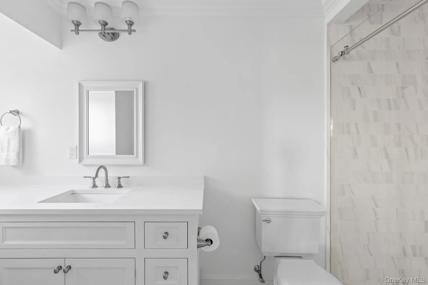 Bathroom with vanity, ornamental molding, and a shower Bathroom with vanity, ornamental molding, and a shower