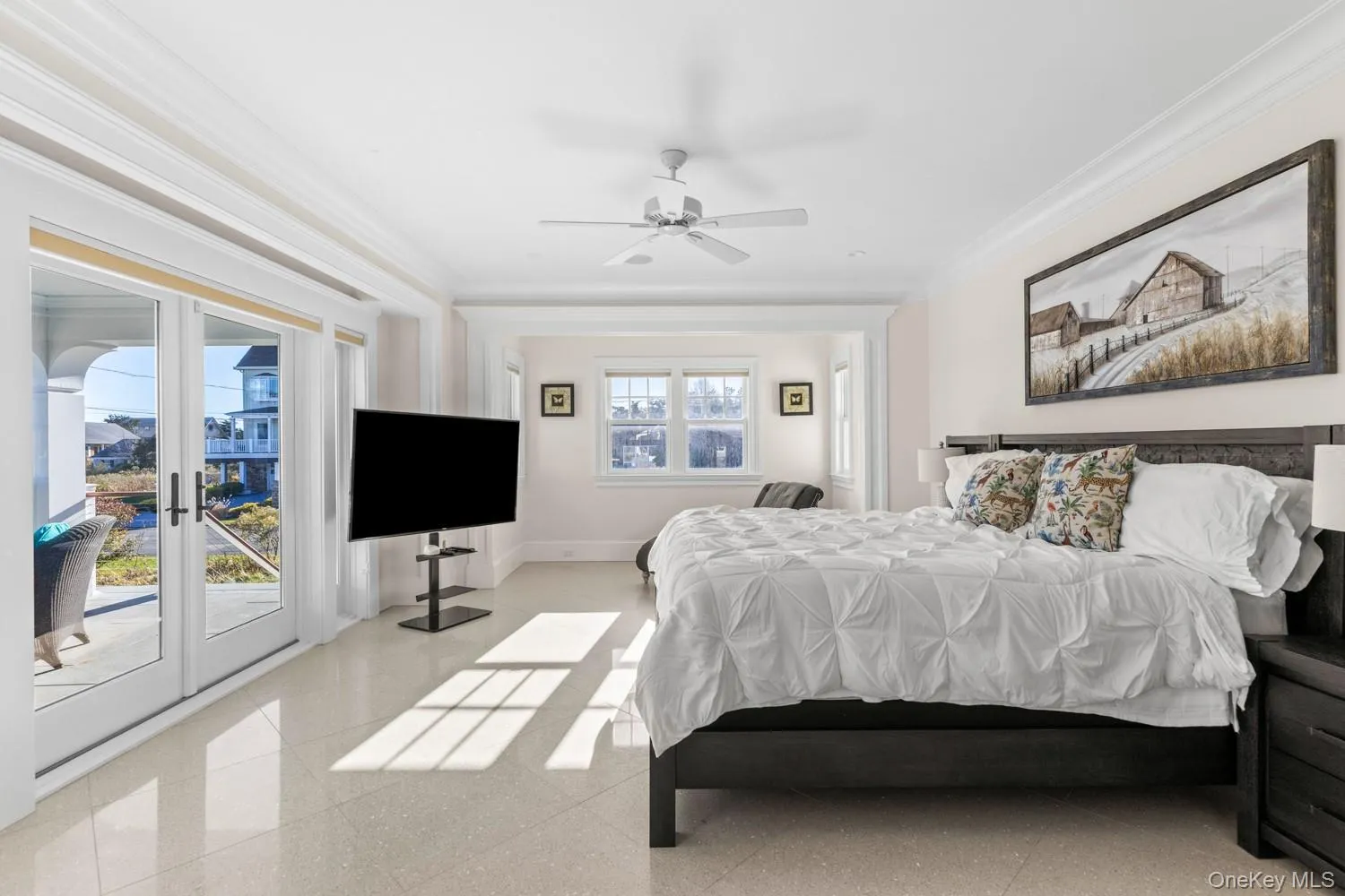 Bedroom with ornamental molding, french doors, a ceiling fan, access to exterior, and dark aggregate flooring Bedroom with ornamental molding, french doors, a ceiling fan, access to exterior, and dark aggregate flooring