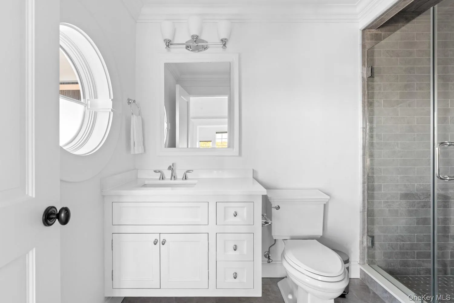 Bathroom with vanity, a shower stall, and crown molding Bathroom with vanity, a shower stall, and crown molding