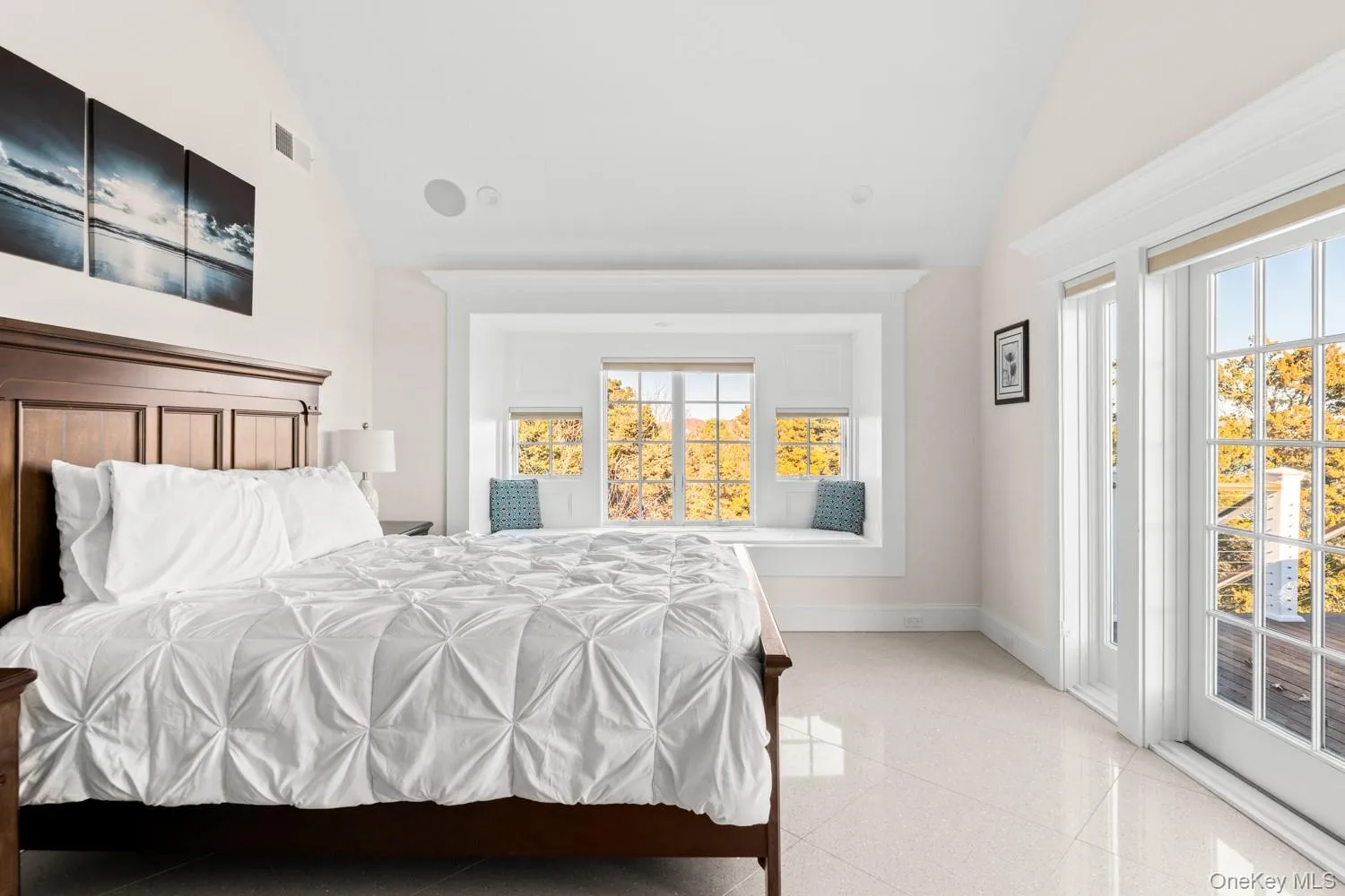 Bedroom featuring lofted ceiling and access to outside Bedroom featuring lofted ceiling and access to outside