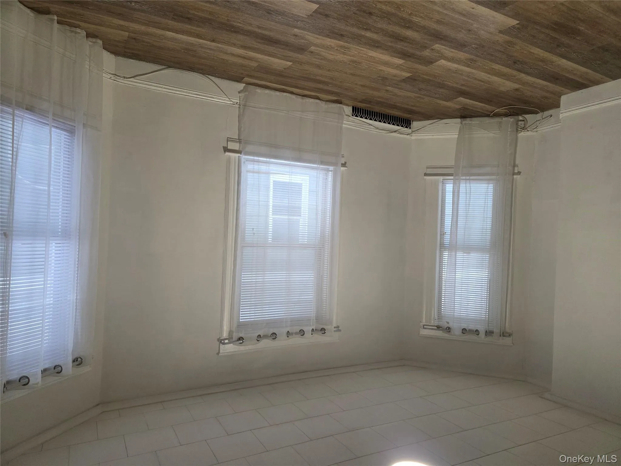 Unfurnished room with dark wood-type flooring and baseboards Unfurnished room with dark wood-type flooring and baseboards