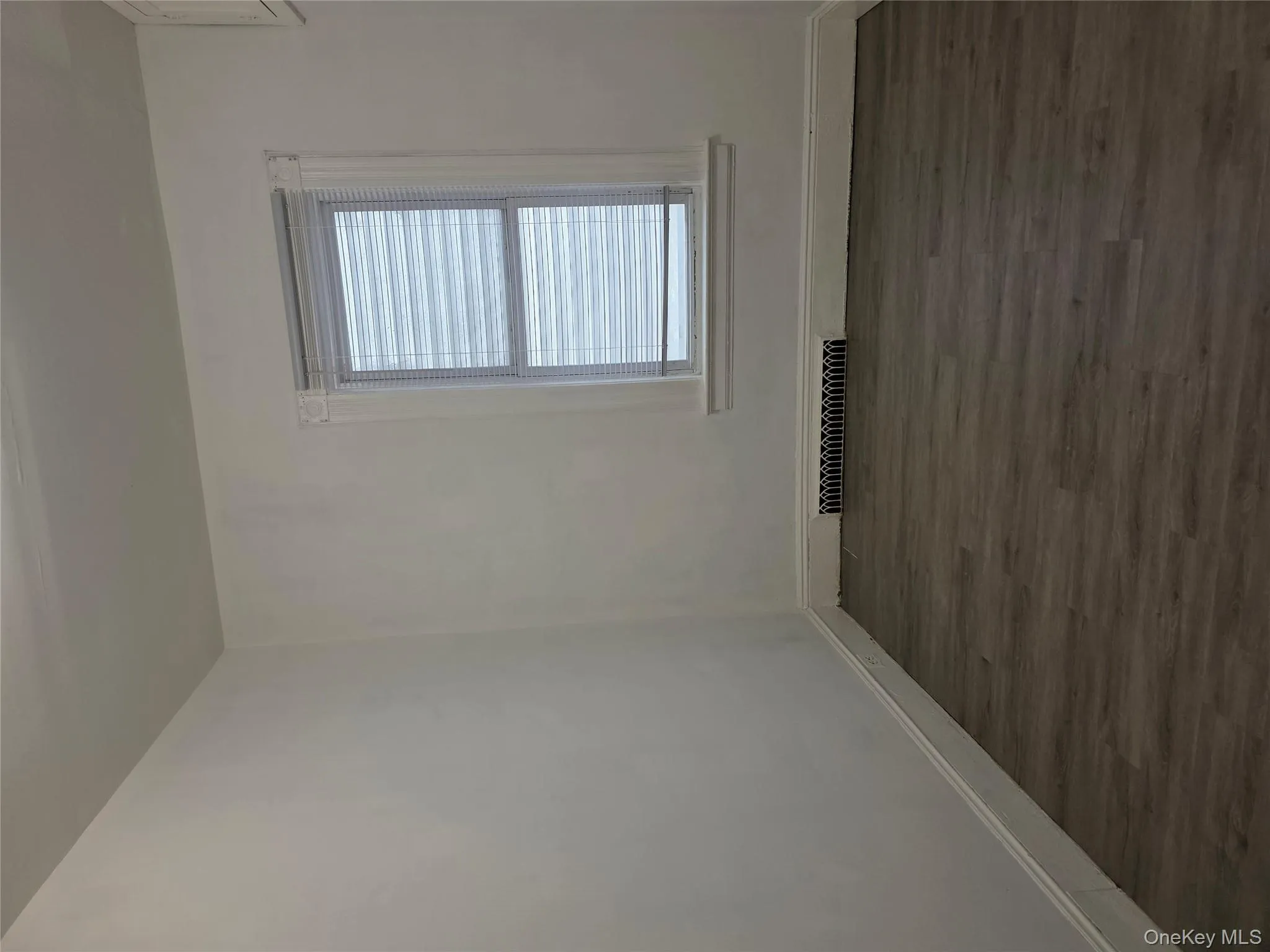 Spare room with dark wood finished floors and baseboards Spare room with dark wood finished floors and baseboards