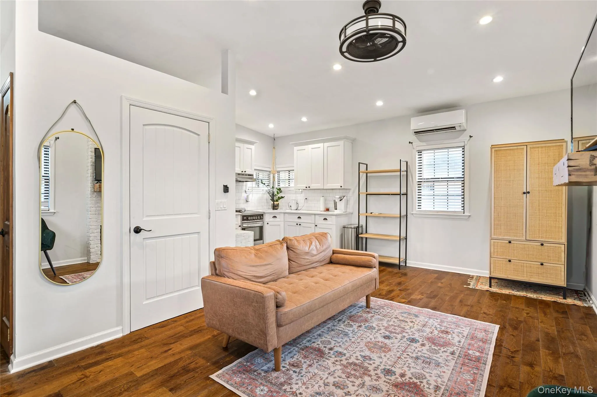 Sitting room with dark wood-style flooring, healthy amount of natural light, recessed lighting, and a wall unit AC Sitting room with dark wood-style flooring, healthy amount of natural light, recessed lighting, and a wall unit AC