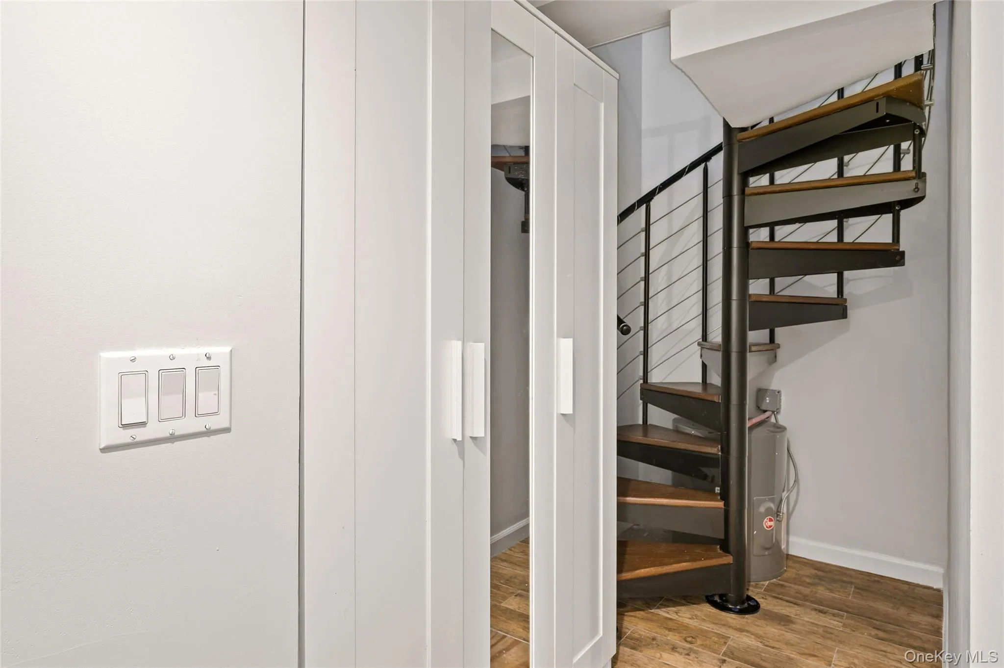 Stairway featuring wood finished floors and baseboards Stairway featuring wood finished floors and baseboards