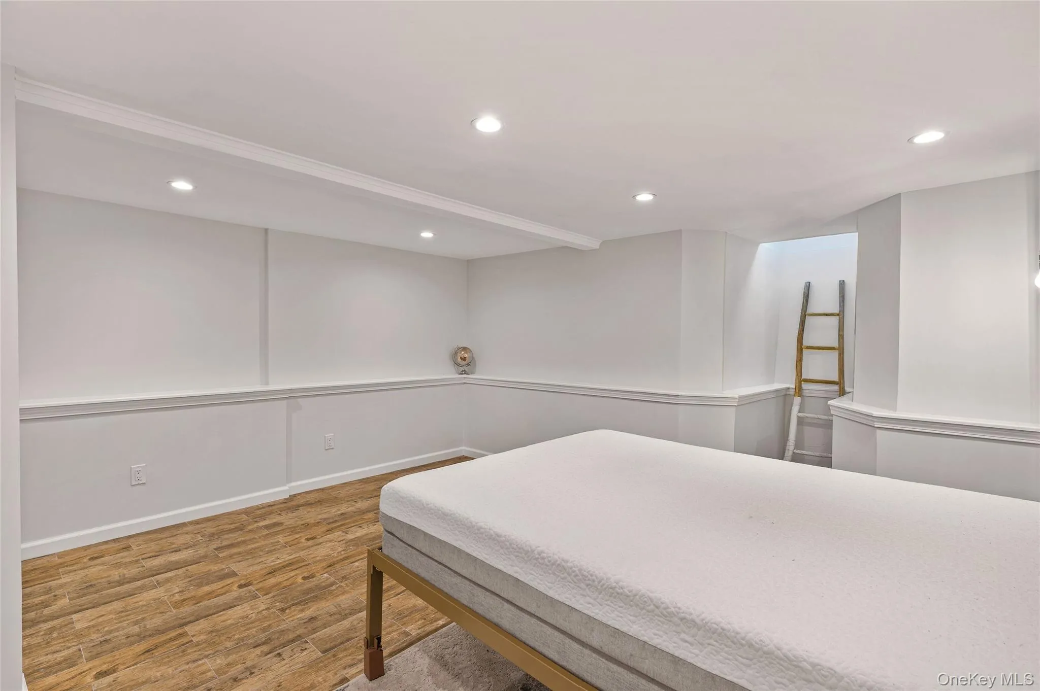 Bedroom featuring recessed lighting and light wood finished floors Bedroom featuring recessed lighting and light wood finished floors