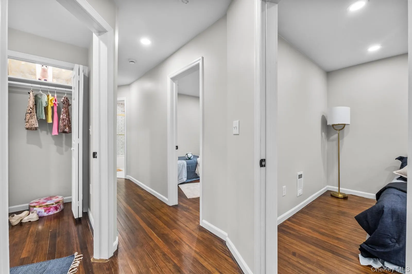Corridor with dark wood-style flooring and recessed lighting Corridor with dark wood-style flooring and recessed lighting