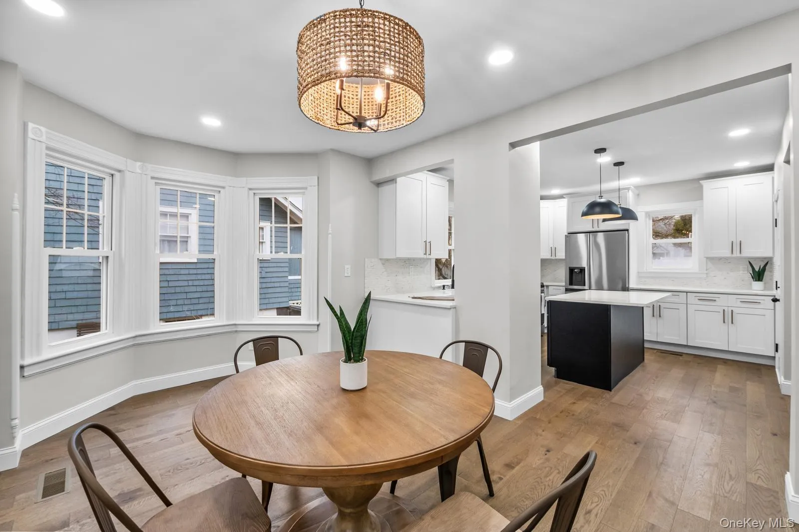Dining area featuring light wood finished floors, a chandelier, and recessed lighting Dining area featuring light wood finished floors, a chandelier, and recessed lighting