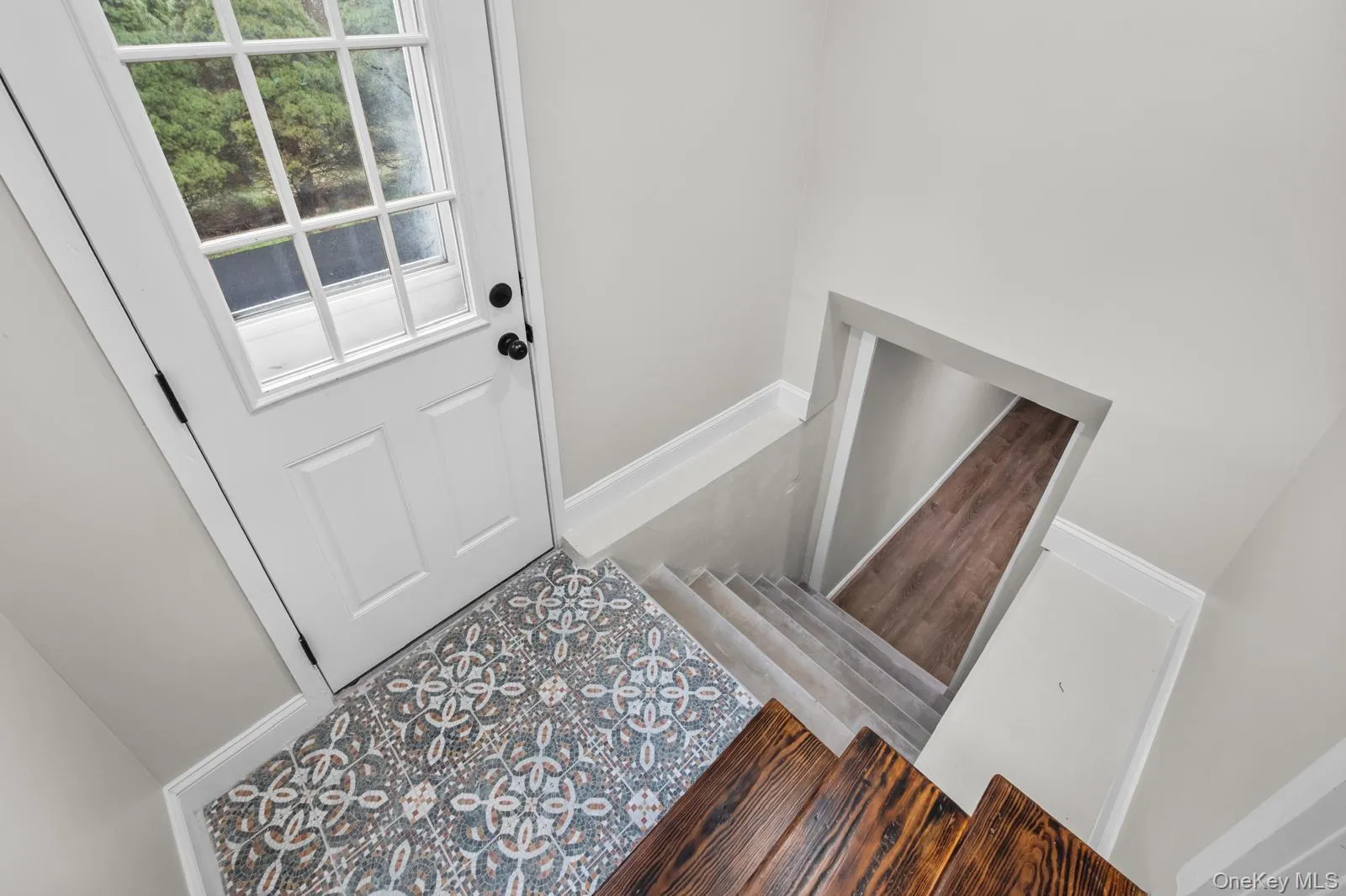 Entryway with stairway and baseboards Entryway with stairway and baseboards