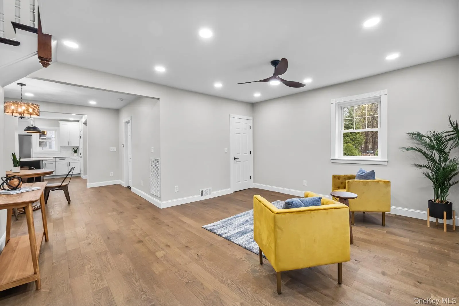Living area featuring light wood finished floors, recessed lighting, and ceiling fan Living area featuring light wood finished floors, recessed lighting, and ceiling fan