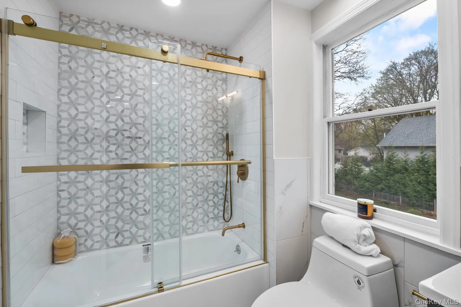 Full bath featuring toilet and bath / shower combo with glass door Full bath featuring toilet and bath / shower combo with glass door