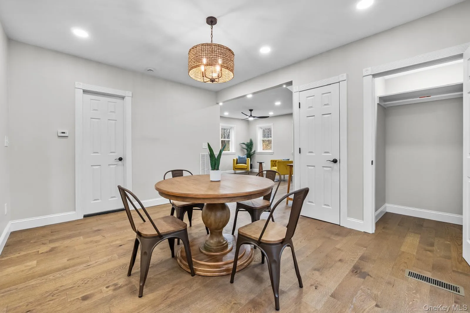 Dining room with light wood-style floors, recessed lighting, and a chandelier Dining room with light wood-style floors, recessed lighting, and a chandelier