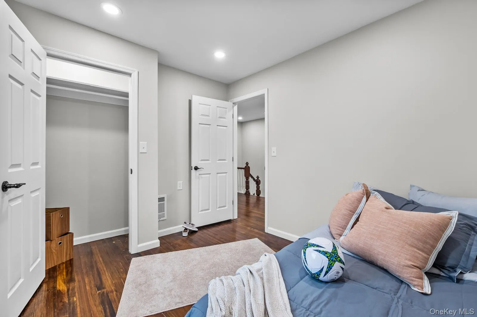 Bedroom with dark wood finished floors, recessed lighting, a closet, and heating unit Bedroom with dark wood finished floors, recessed lighting, a closet, and heating unit
