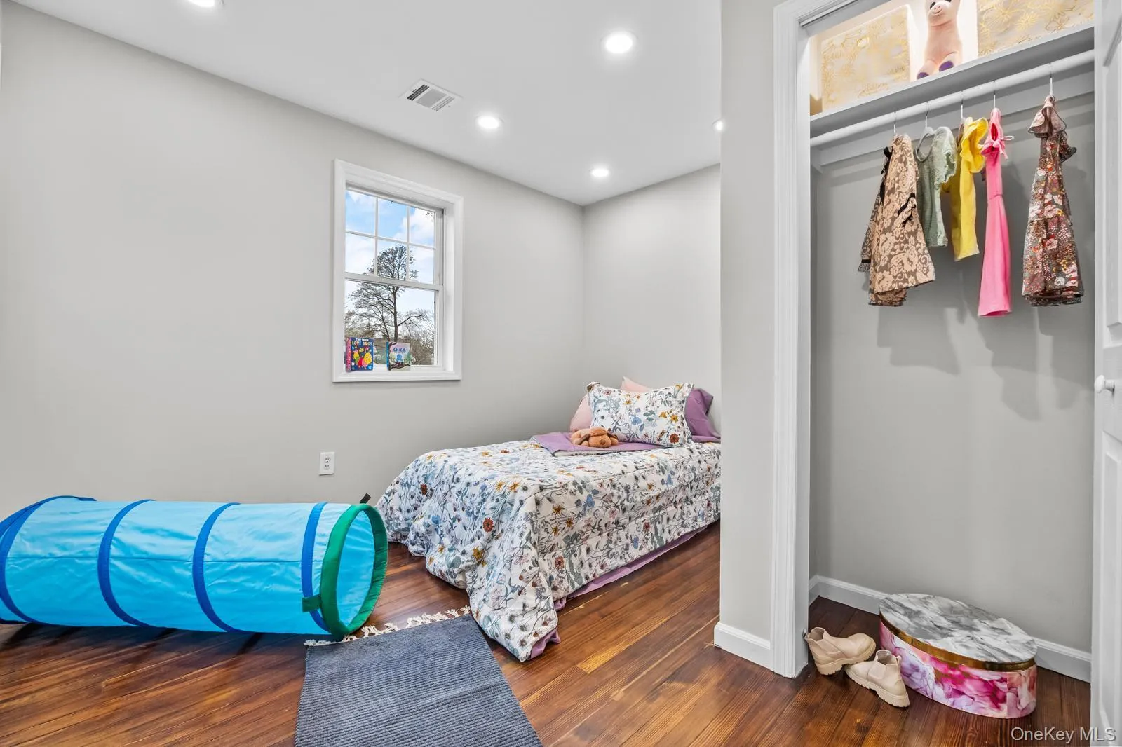 Bedroom with recessed lighting, dark wood-style flooring, and a closet Bedroom with recessed lighting, dark wood-style flooring, and a closet