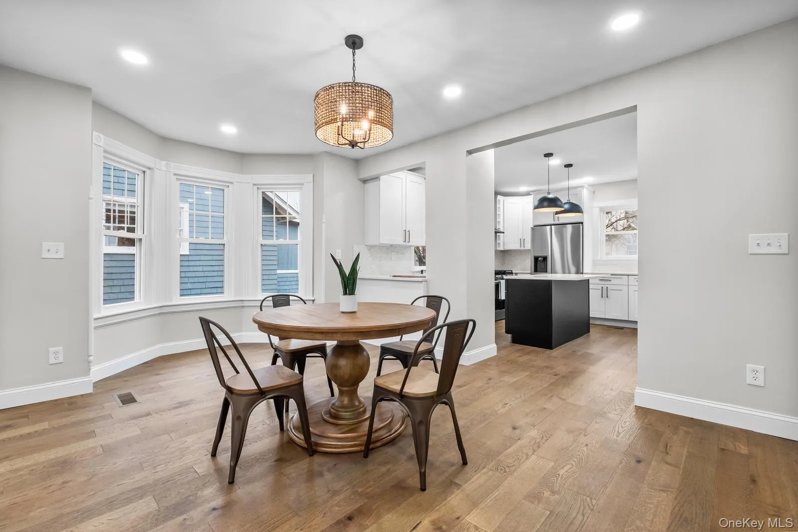 Dining room featuring light wood-type flooring and recessed lighting Dining room featuring light wood-type flooring and recessed lighting