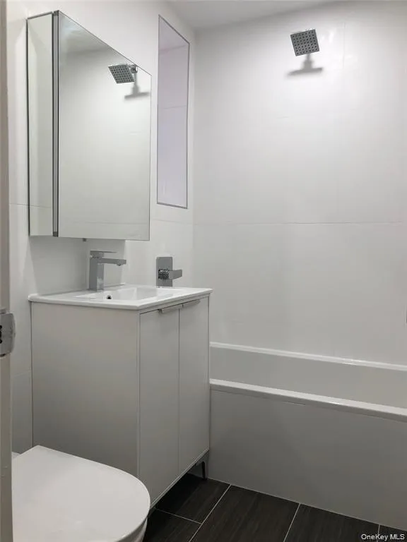 Full bathroom with vanity and shower / bath combination Full bathroom with vanity and shower / bath combination
