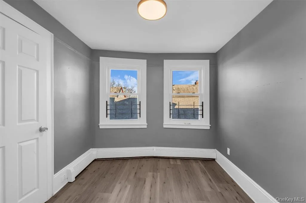 Bedroom with light wood finished floors and baseboards Bedroom with light wood finished floors and baseboards