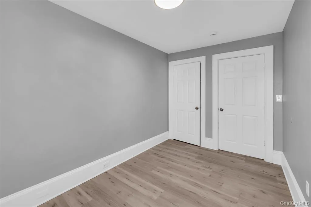 bedroom featuring light wood-type flooring and a closet bedroom featuring light wood-type flooring and a closet