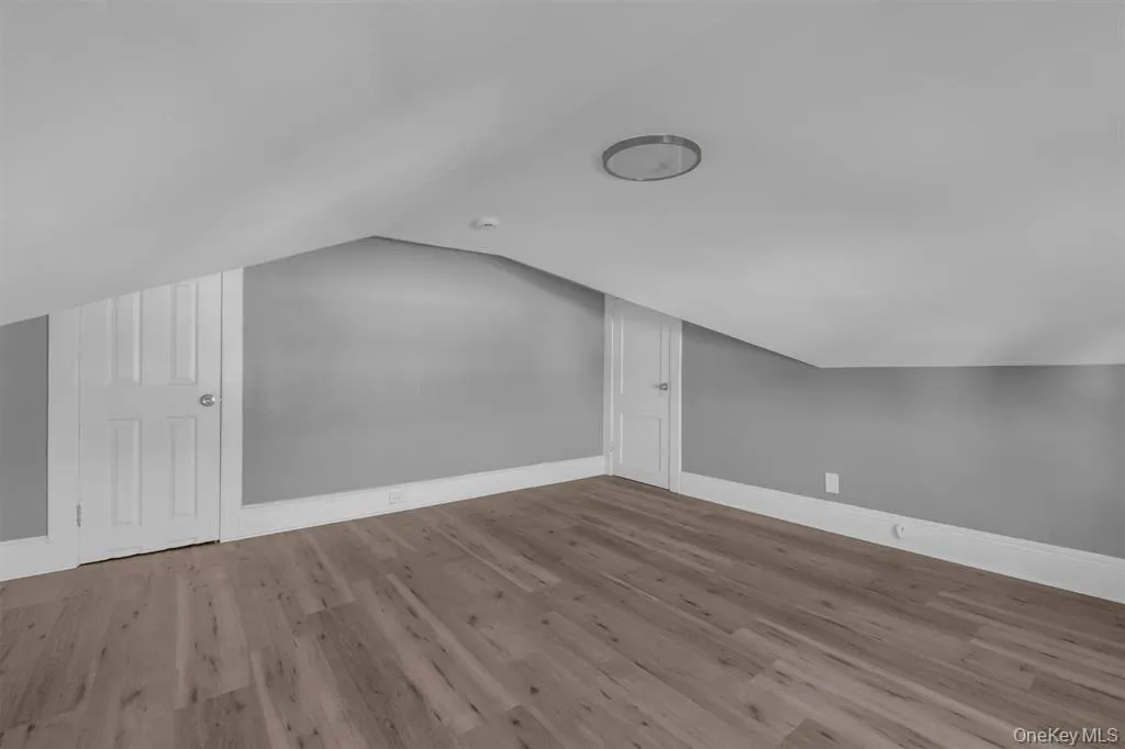 Additional living space with vaulted ceiling and wood finished floors Additional living space with vaulted ceiling and wood finished floors