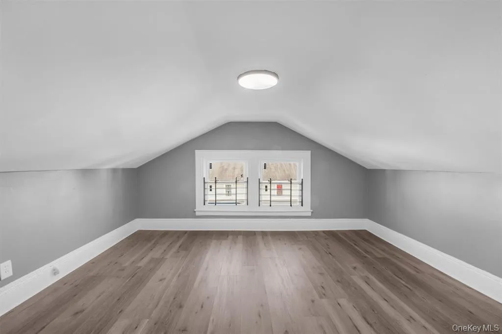 Additional living space with light wood finished floors and lofted ceiling Additional living space with light wood finished floors and lofted ceiling