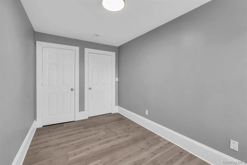 bedroom featuring wood finished floors and a closet bedroom featuring wood finished floors and a closet