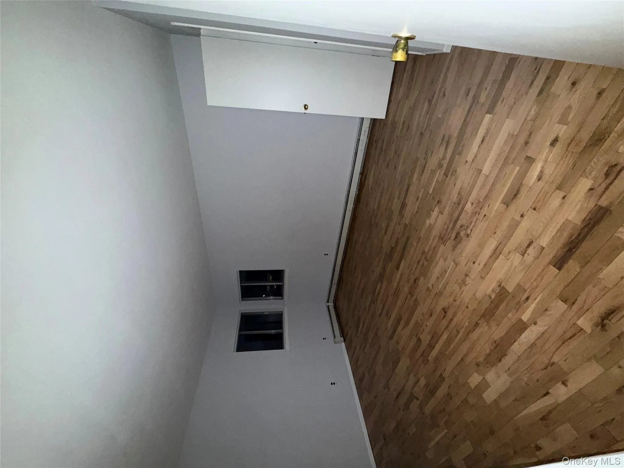 Empty room featuring wood finished floors and a baseboard heating unit Empty room featuring wood finished floors and a baseboard heating unit