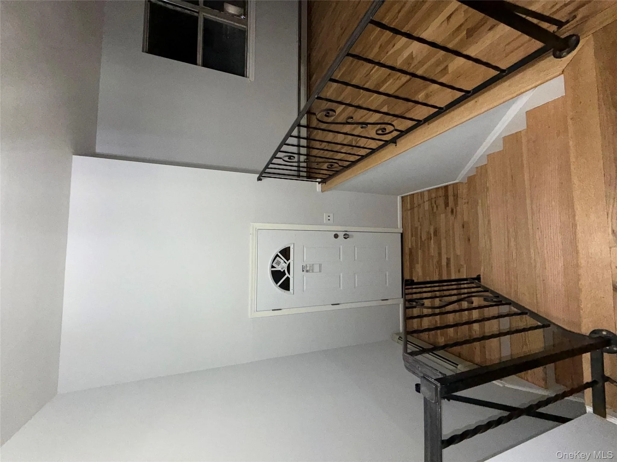 Stairway featuring wood finished floors Stairway featuring wood finished floors