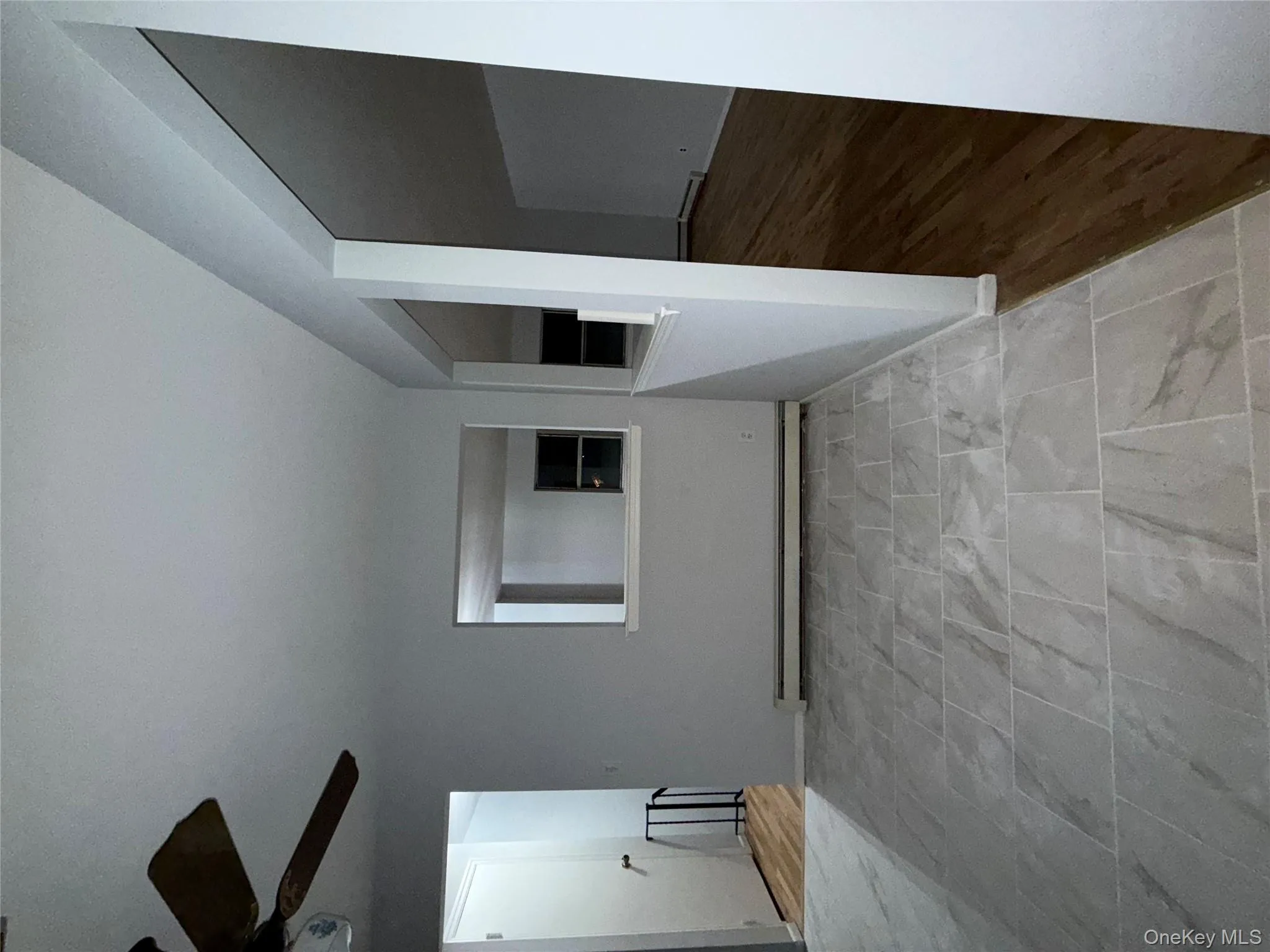 Empty room with baseboard heating, light wood-style floors, and a ceiling fan Empty room with baseboard heating, light wood-style floors, and a ceiling fan