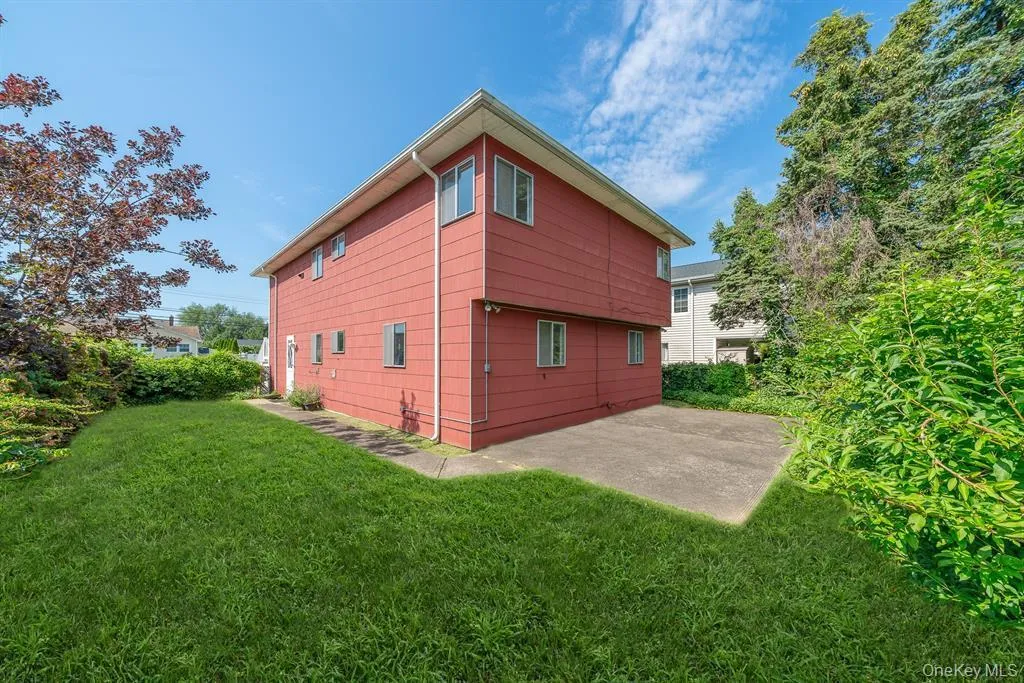 View of home's exterior with a yard and a patio View of home's exterior with a yard and a patio