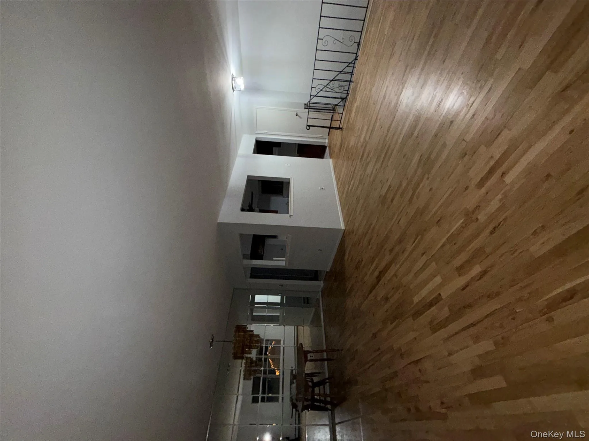 Living area with wood finished floors and a chandelier Living area with wood finished floors and a chandelier