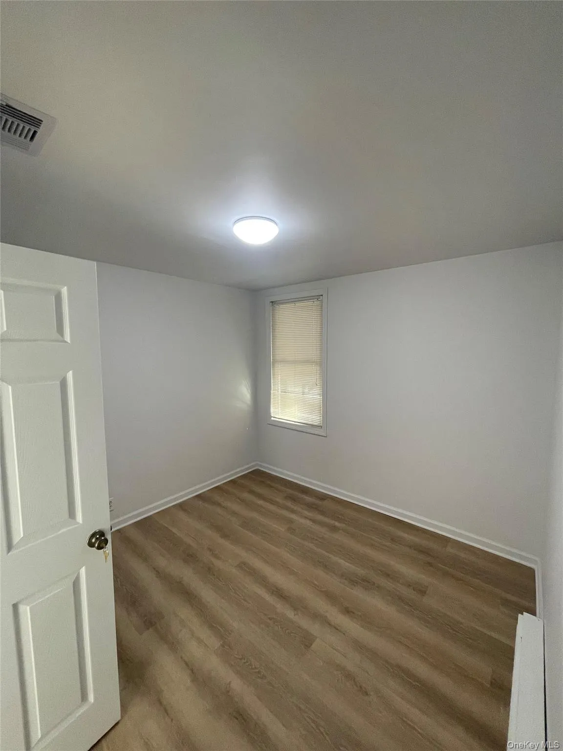 Unfurnished room featuring light wood-style flooring and baseboards Unfurnished room featuring light wood-style flooring and baseboards