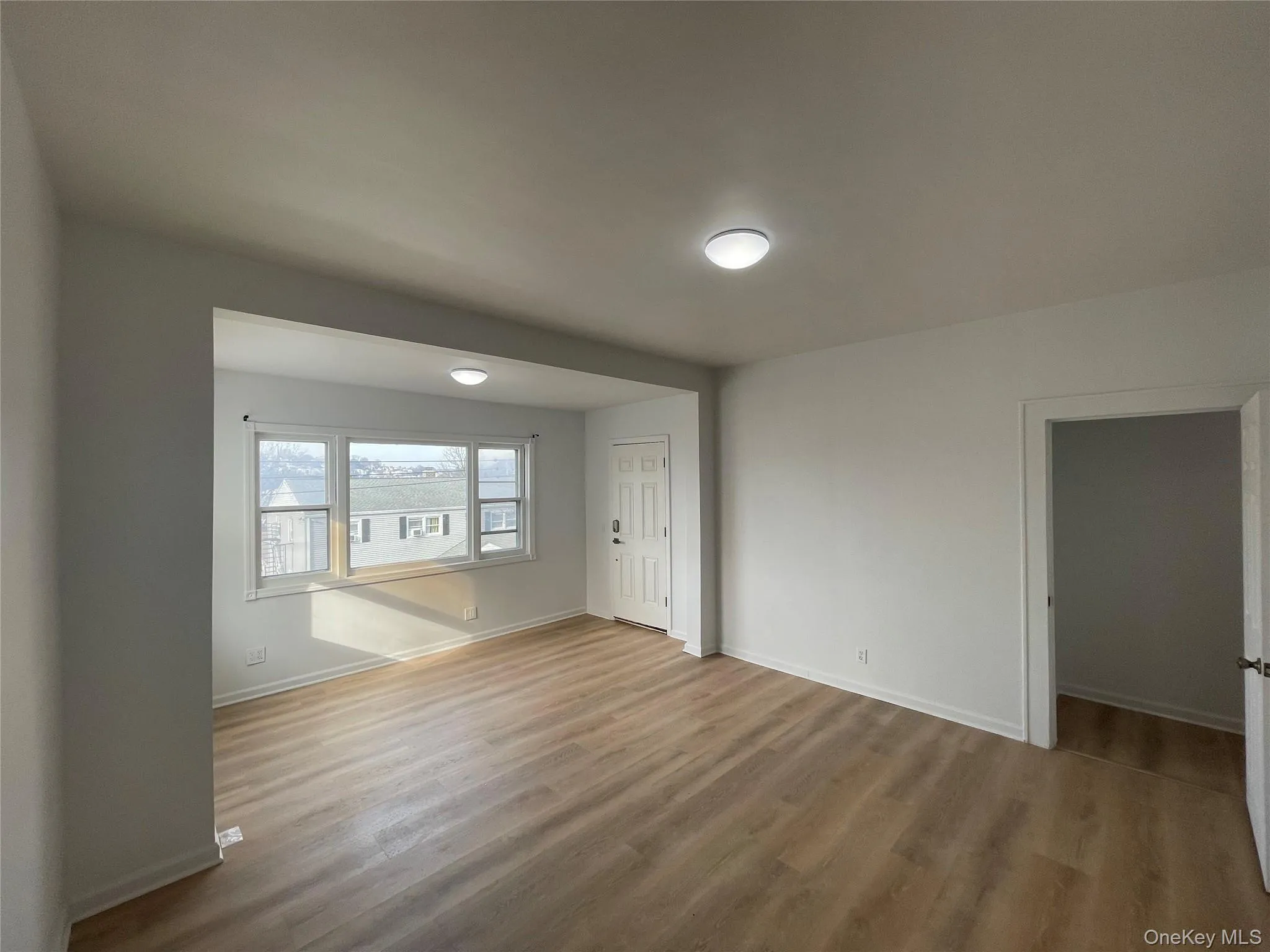 Empty room featuring light wood-style flooring and baseboards Empty room featuring light wood-style flooring and baseboards