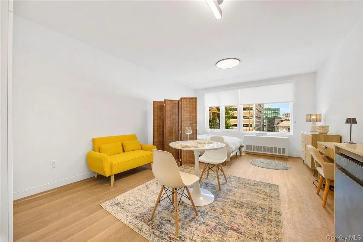 Dining area featuring light wood finished floors and radiator heating unit Dining area featuring light wood finished floors and radiator heating unit