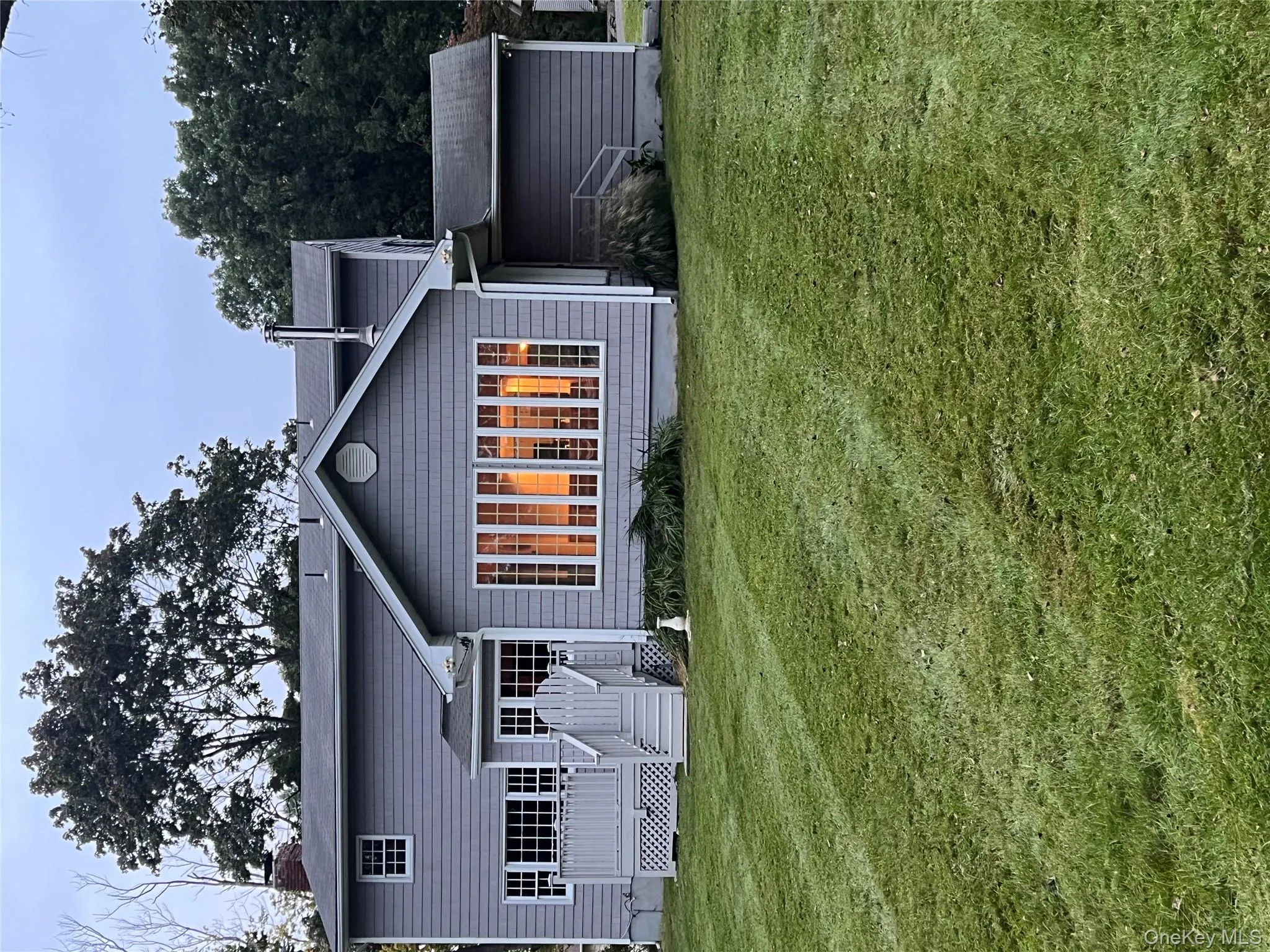 Back of house with a yard, a deck, and a chimney Back of house with a yard, a deck, and a chimney