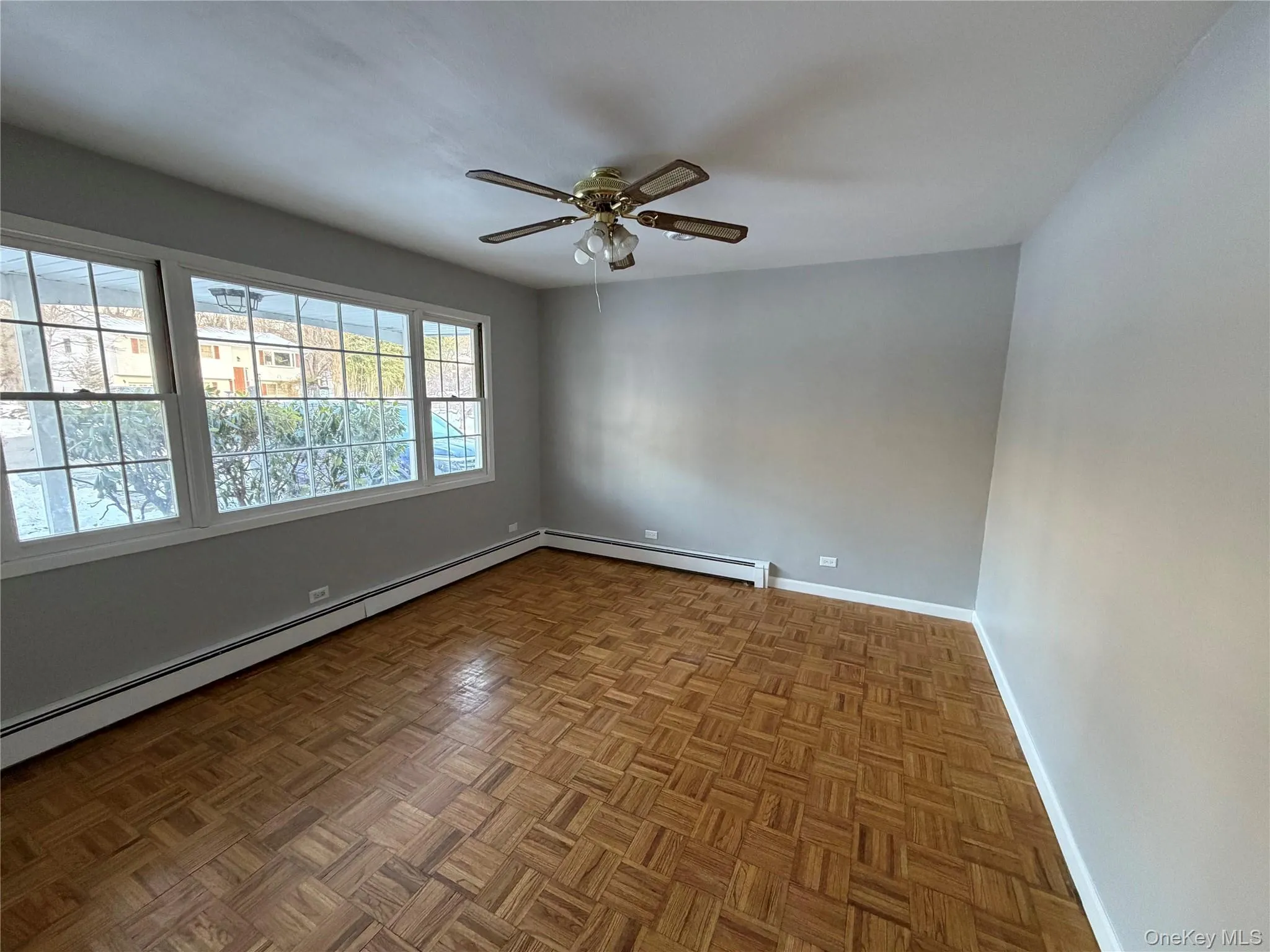 Spare room featuring a baseboard radiator and a ceiling fan Spare room featuring a baseboard radiator and a ceiling fan