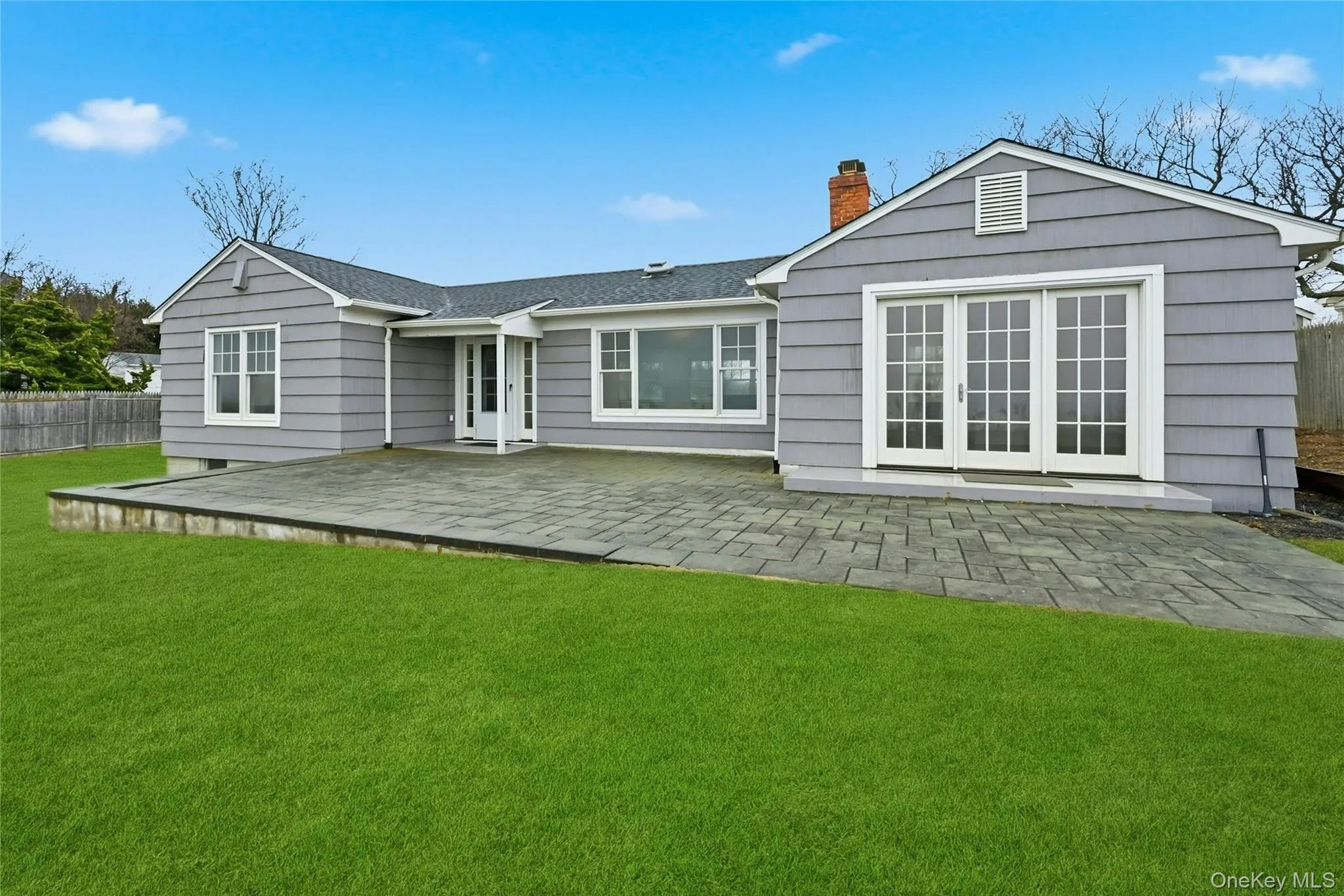 Back of house featuring a patio and a chimney Back of house featuring a patio and a chimney